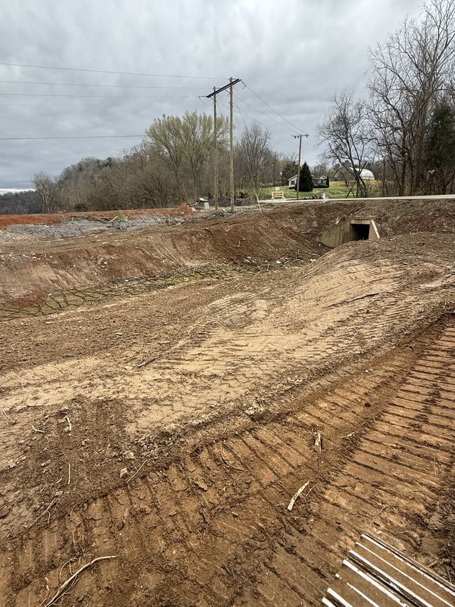 Large graded drainage ditch leading to a concrete box culvert on a rural western North Carolina property